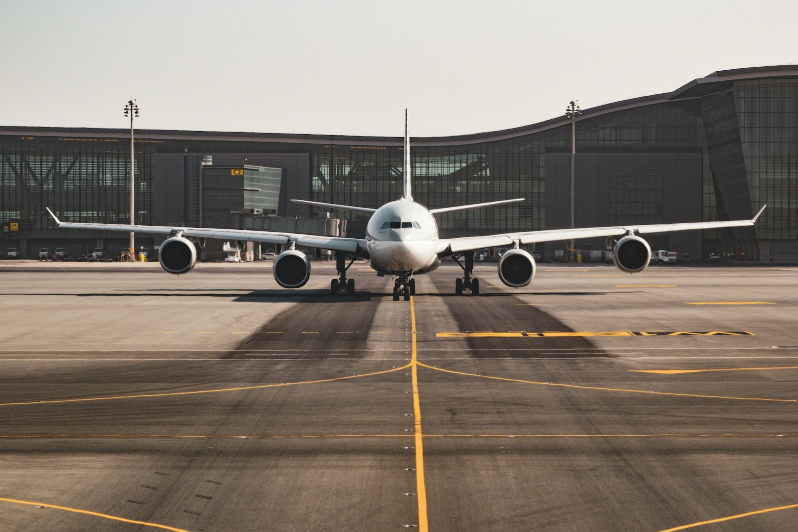 An international flight arriving at a modern airport terminal