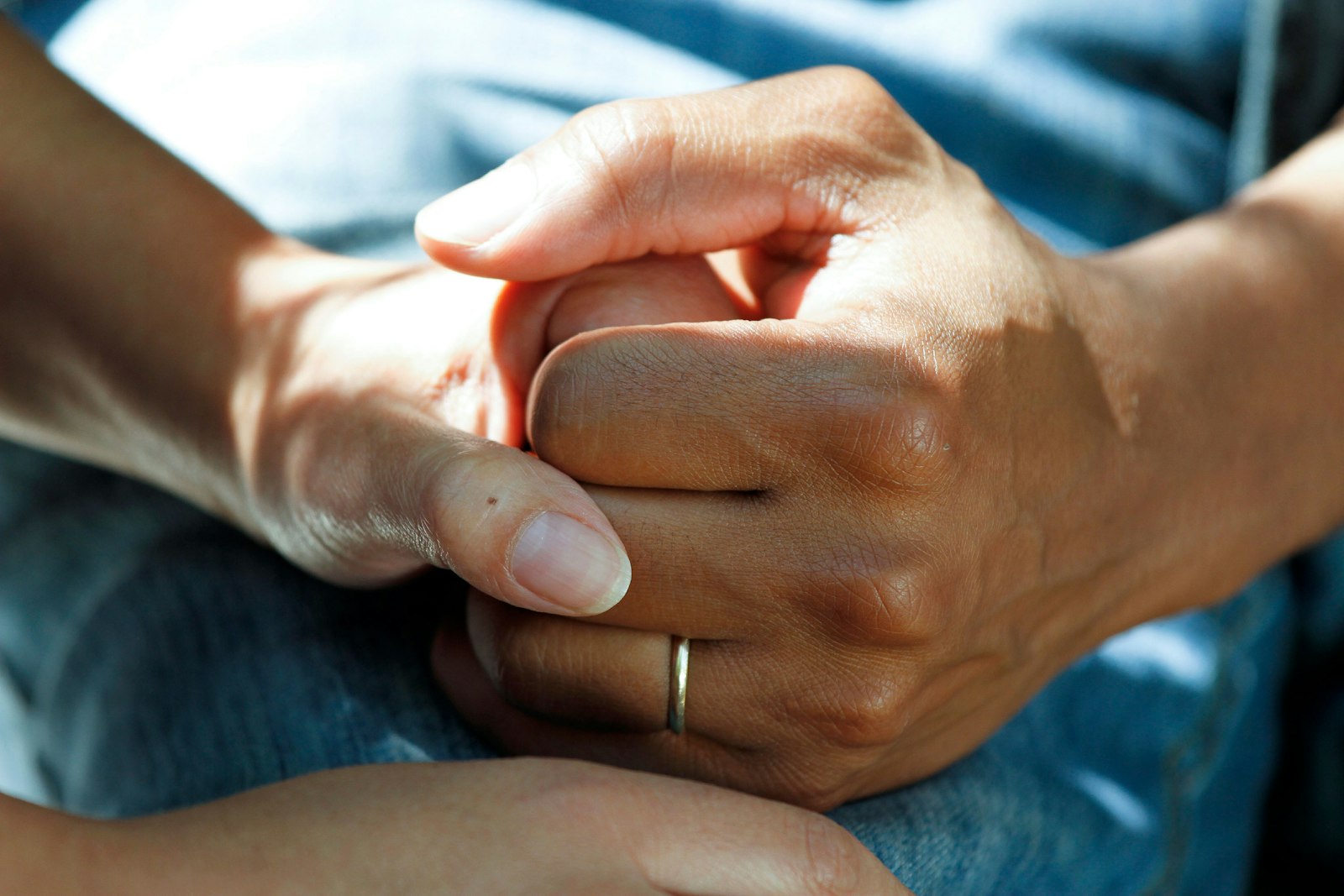 A coordinator reassuring a patient, hand in hand
