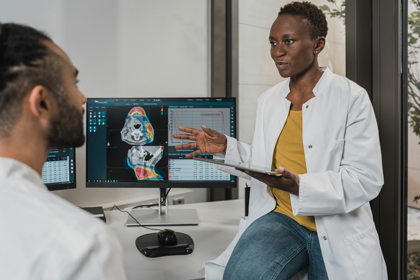 Specialists reviewing a patient's scans and treatment plan together